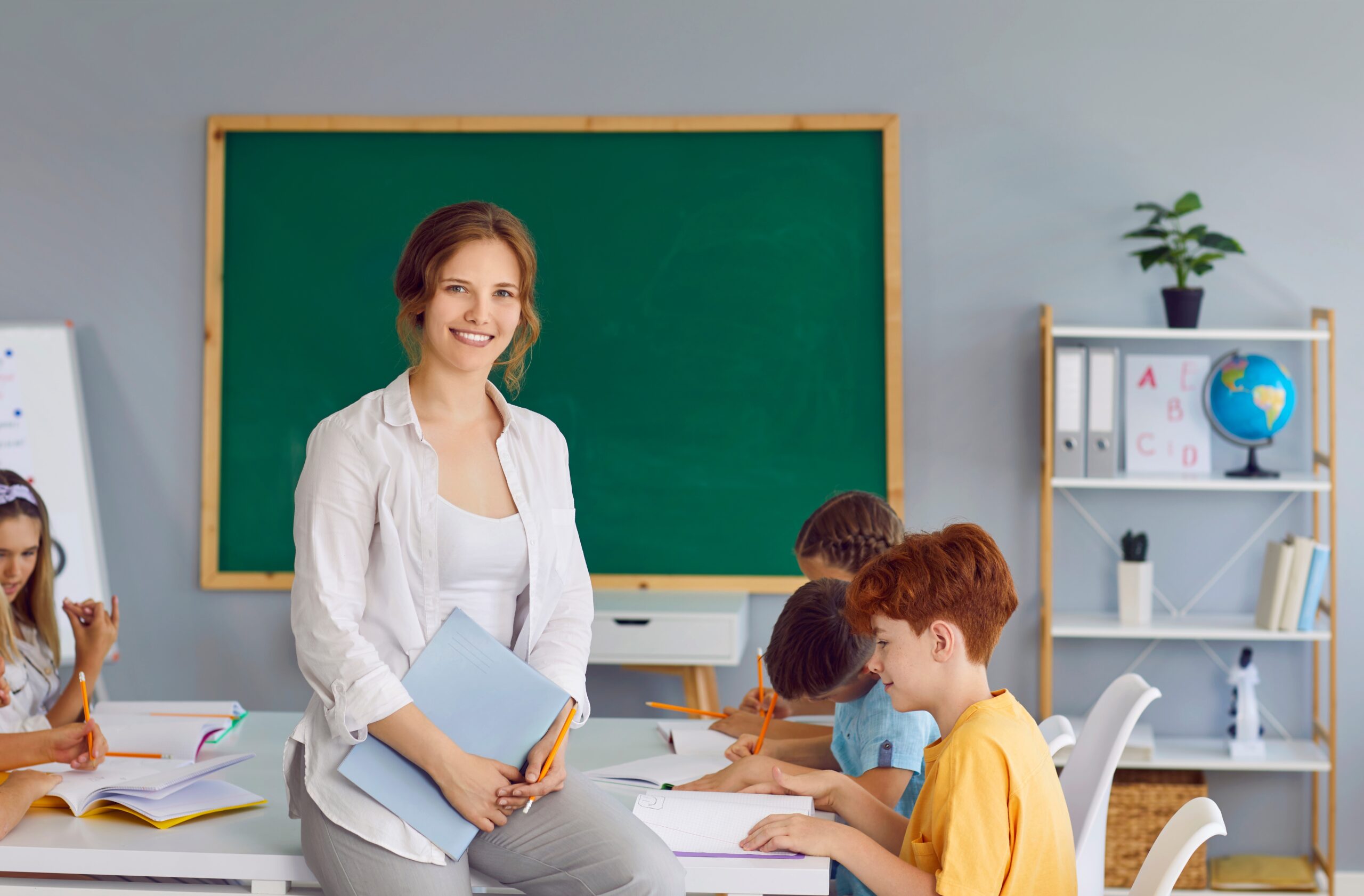 Portrait,Of,Beautiful,Smiling,Female,Teacher,In,School,Classroom,On