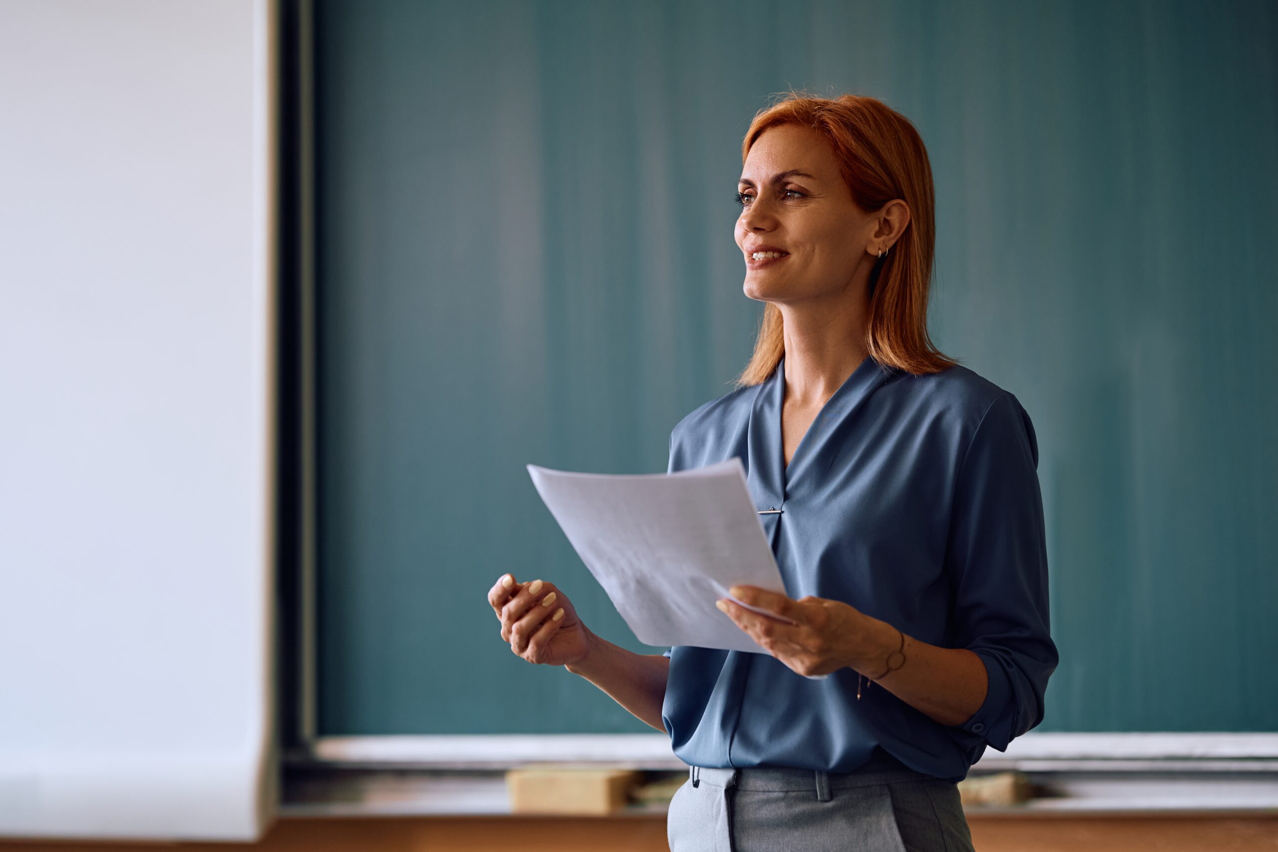 Happy,Female,Teacher,Talking,During,A,Lecture,In,The,Classroom.