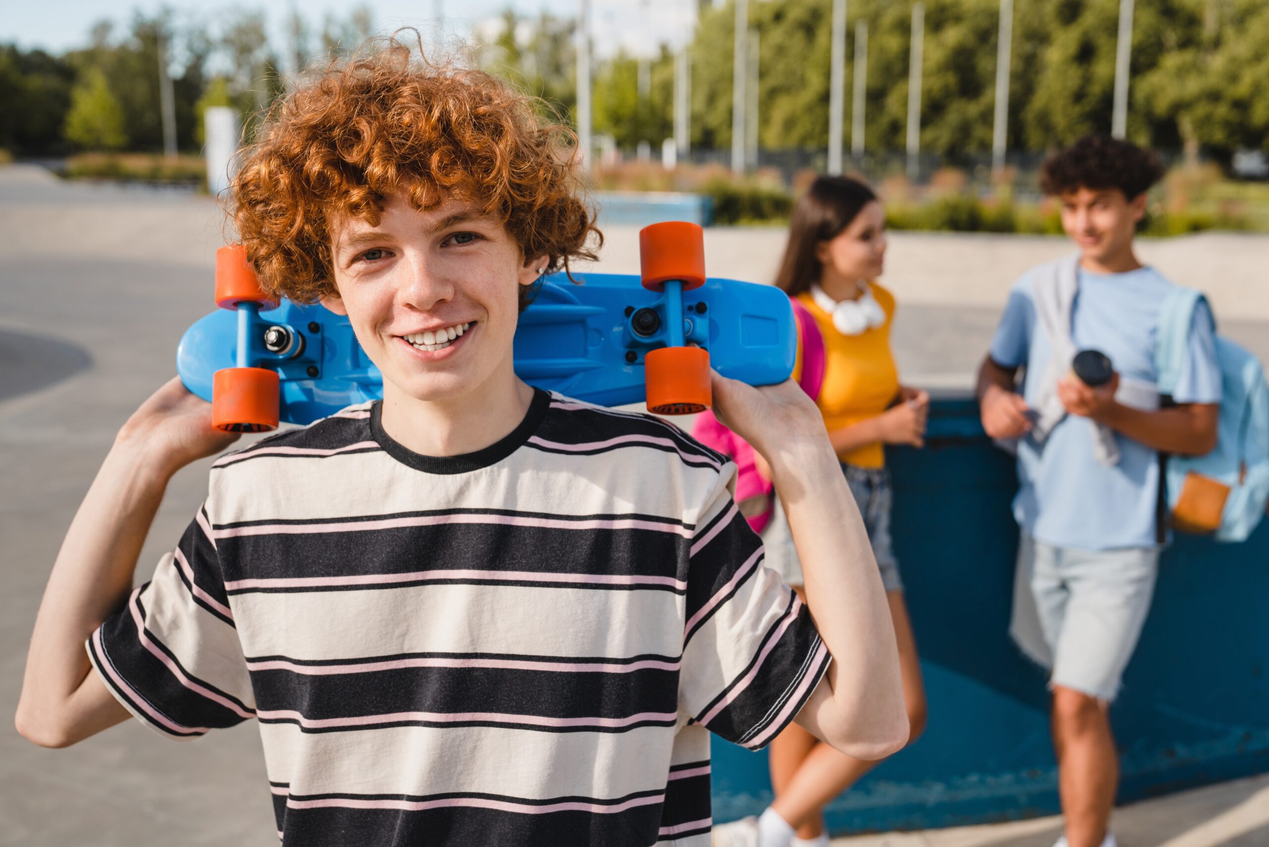 Smiling,Redhead,Curly,Teen,Boy,In,Sporty,Casual,Outfit,Holding