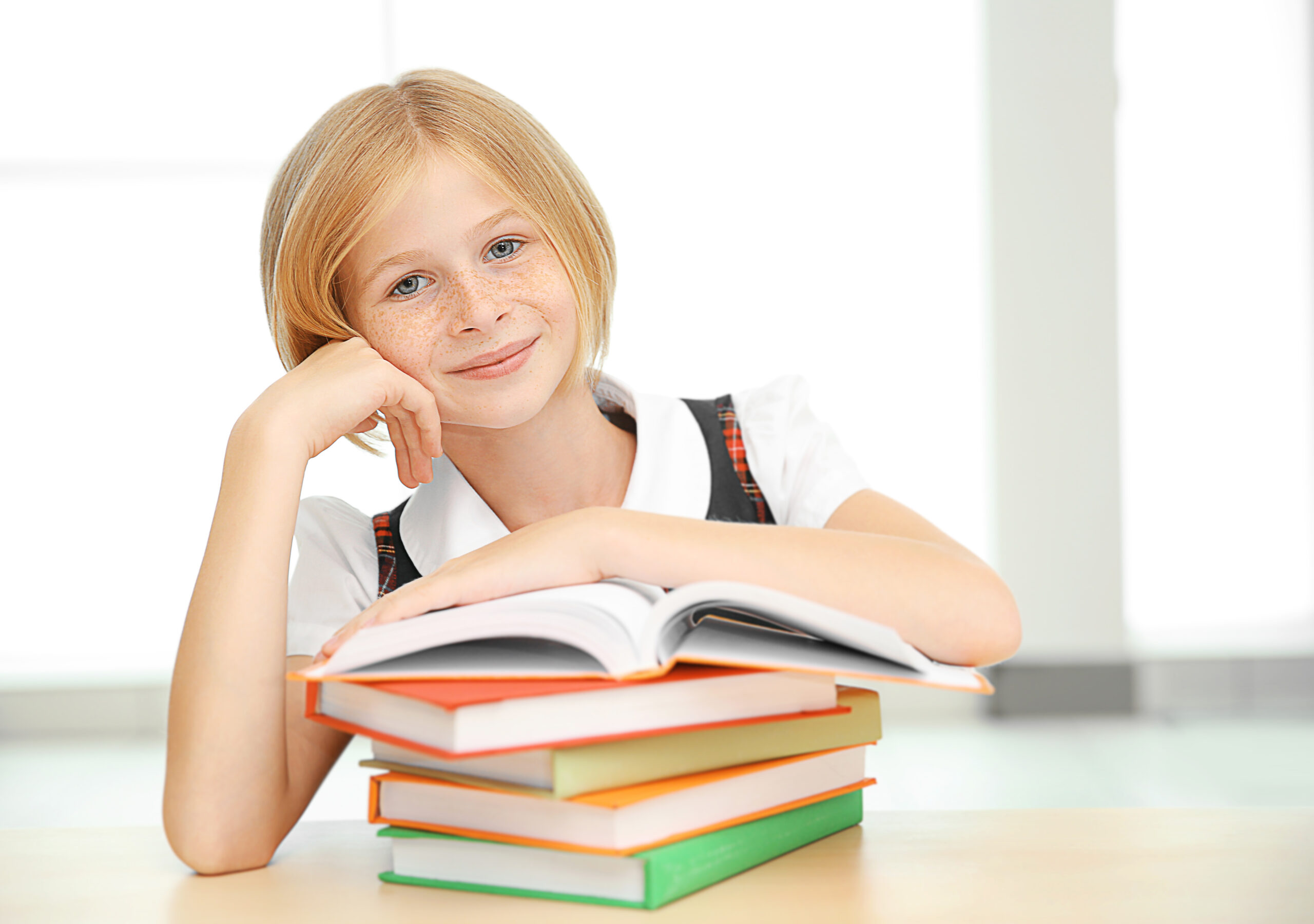 Smiling,Girl,With,Many,Books,At,School