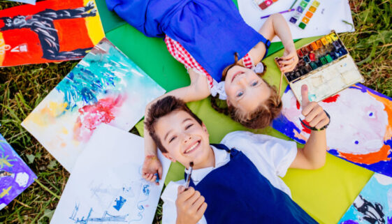 Authentic,Artist,Children,In,Blue,Aprons,Girl,And,Boy,Paints