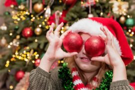 Holiday,Joy,Child,Wearing,Santa,Hat,And,Holiday,Scarf,Holding