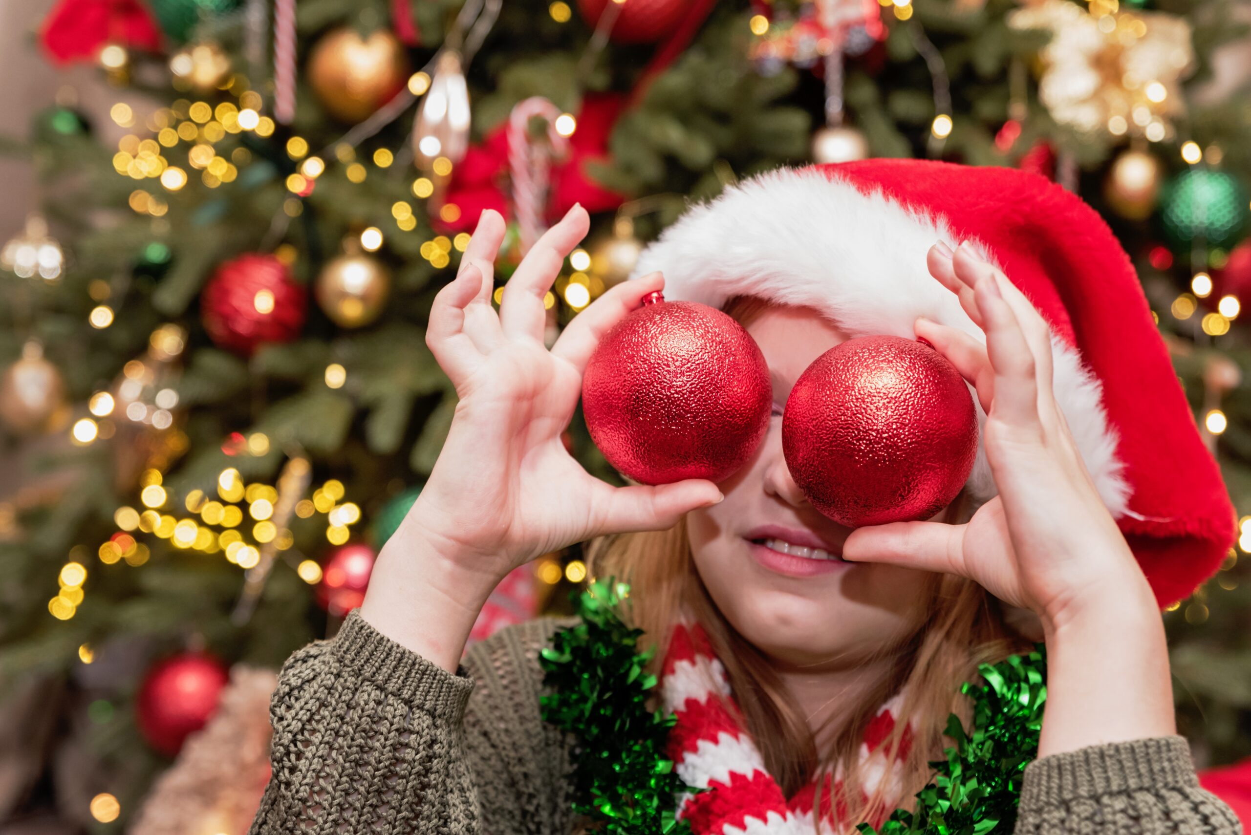 Holiday,Joy,Child,Wearing,Santa,Hat,And,Holiday,Scarf,Holding